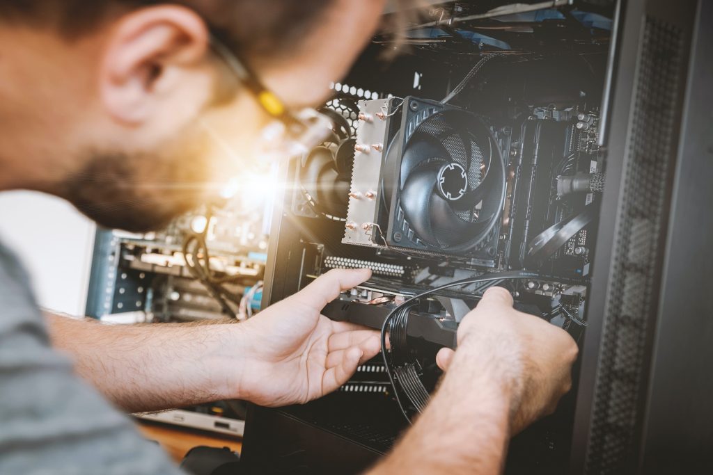 IT professional working on server rack.