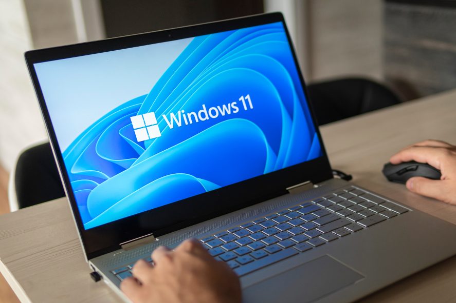 Windows 11 logo on laptop screen. A new operating system