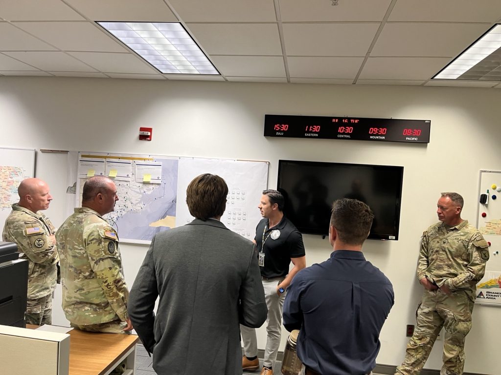 Image of Cyber Fusion event held in North Carolina with civilian and military members in a room discussing cyber security 