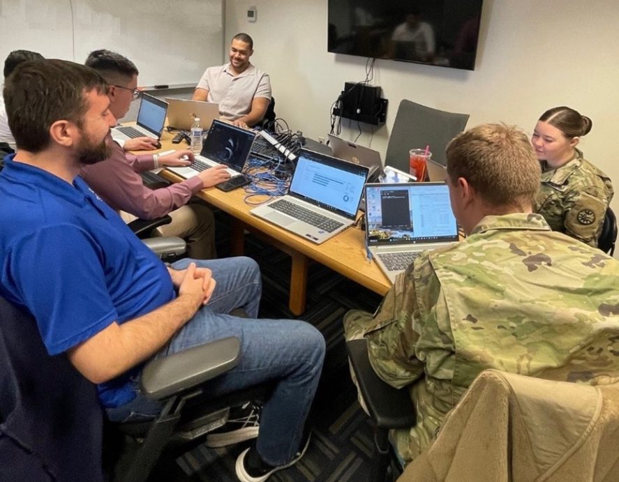 Solomon Ross working with members of IDARNG and students from Boise State's CORe program for a cyber reconnaissance training.