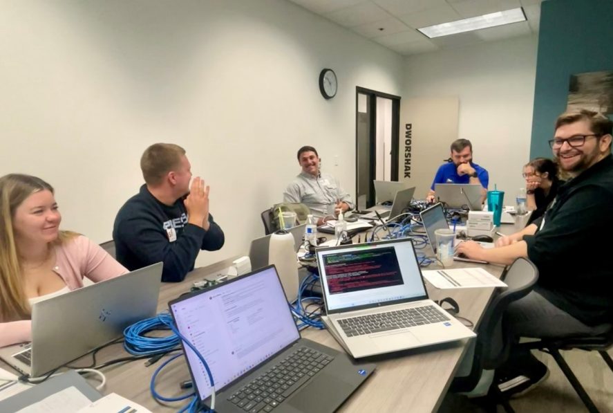 Cybersecurity interns and students working together