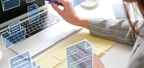 Young businesswoman with sticky note papers, laptop and digital
