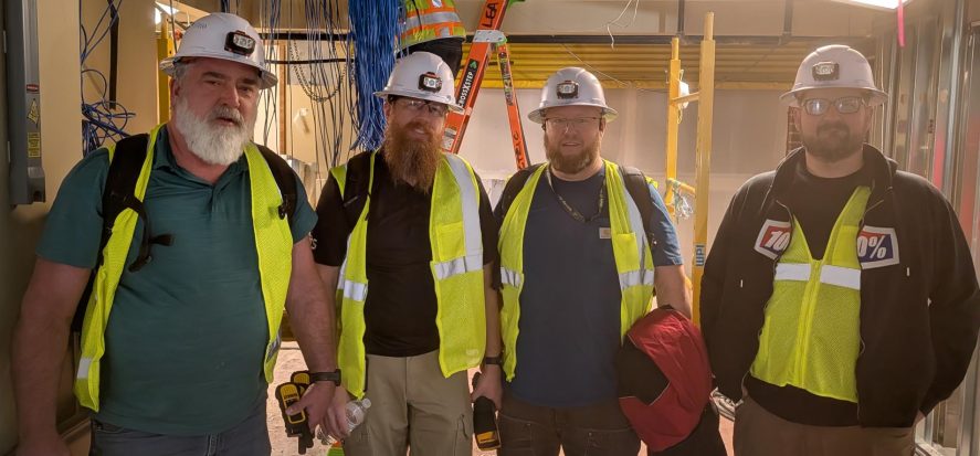 ITS networking team wearing safety helmets and vests.
