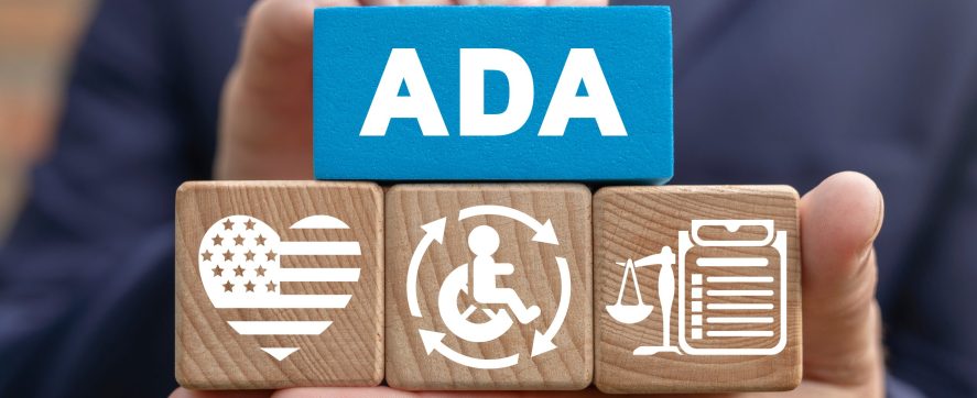 hand holds wooden blocks with ADA written on a blue block above icons