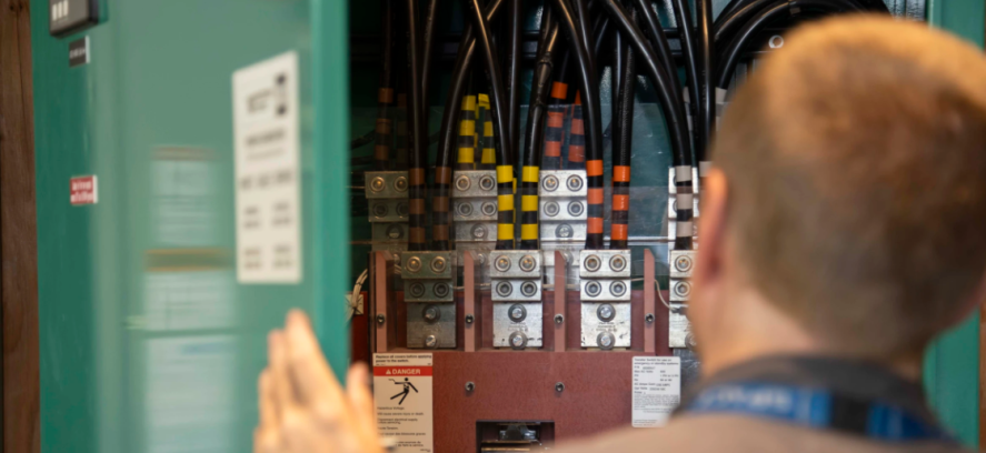 Technician working on fuse box